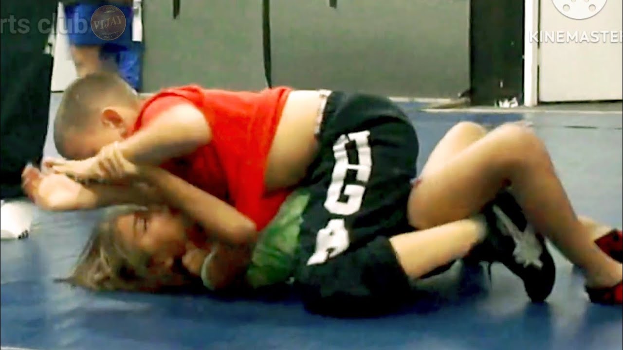 Clash on the Mat: Girl Takes on Boy in Raw Wrestling”#sports #wwe #workout 