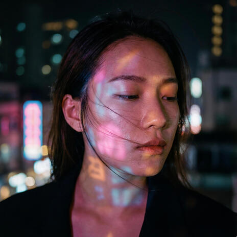 City lights on her skin cover art