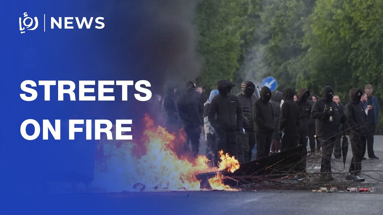 Fires in Belfast as black-clad protesters take to streets after stabbing cover art