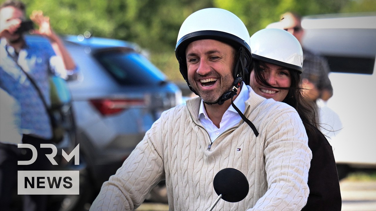 AfD's Ulrich Siegmund and His Wife Ride Blue Scooter to Vote | DRM News | AC1F cover art